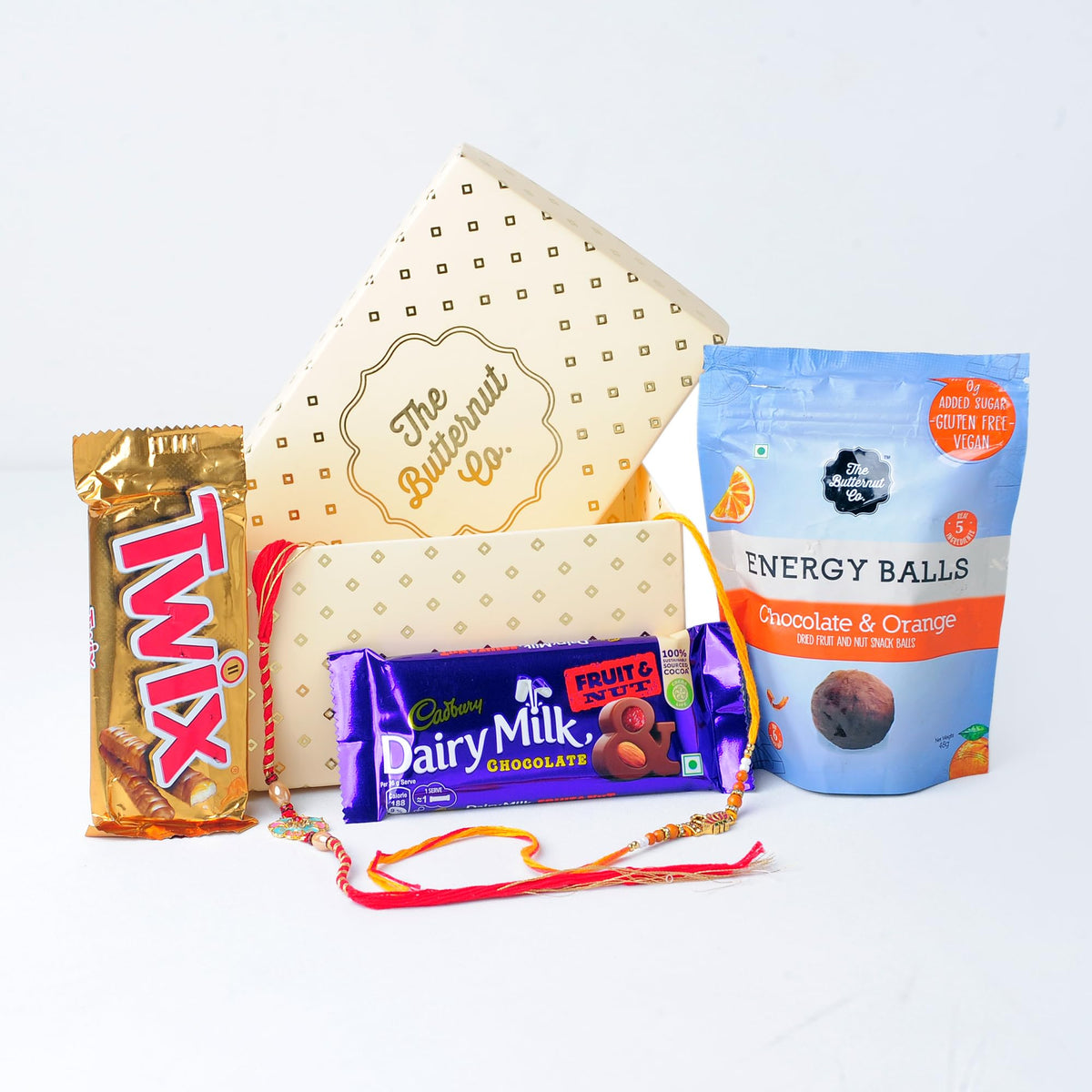 The Butternut Co Rakhi Gift Set | Rakhi For Brother And Bhabhi | Chocolate Gift Pack I Cadbury Chocolates With Rakhi I Protein Energy Balls I Fruit And Nut | Twix Chocolate | 2 Rakhis